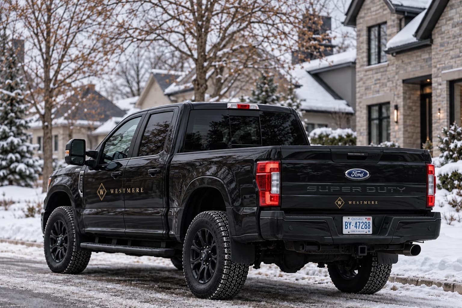 Brand visualization of a black Ford F-250 Super Duty with discreet gold Westmere diamond logos on a snowy residential street